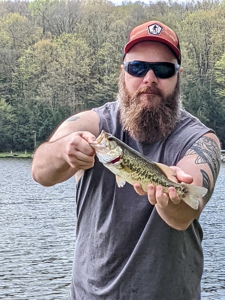 Adam, ReelRank co-founder, holding a bass