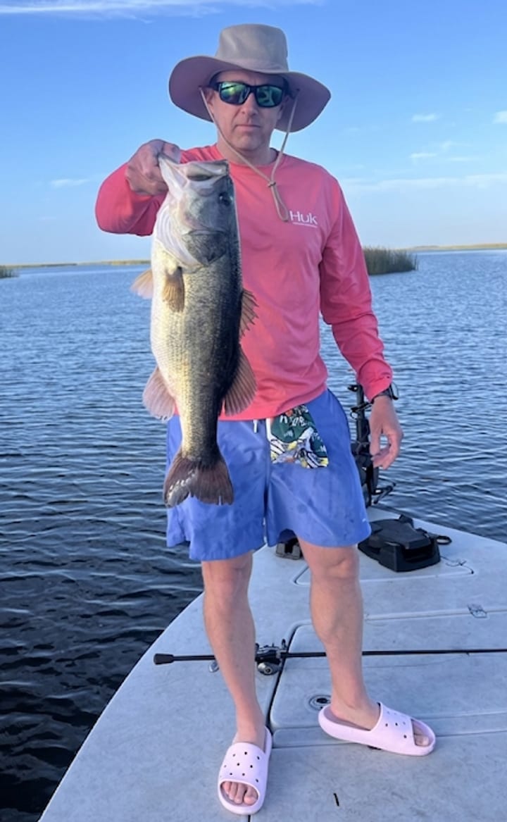 Phil, ReelRank co-founder, holding a bass